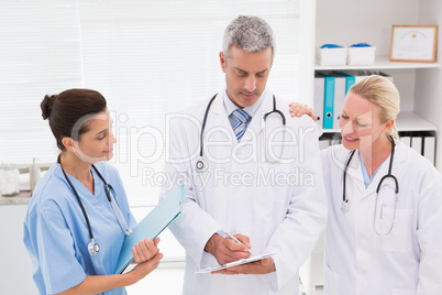 Doctors looking at clipboard