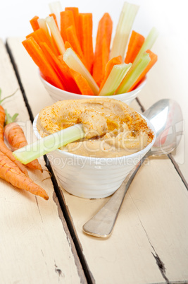 fresh hummus dip with raw carrot and celery