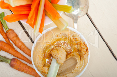 fresh hummus dip with raw carrot and celery