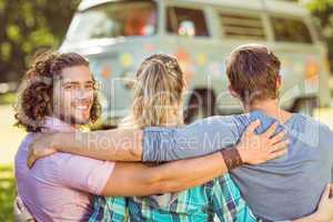 Hipster smiling at camera with friends