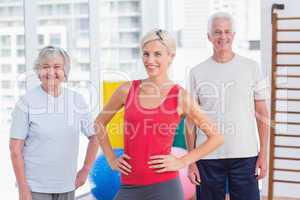 Confident female instructor with senior couple