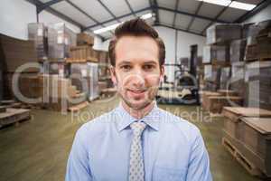 Smiling male manager in warehouse