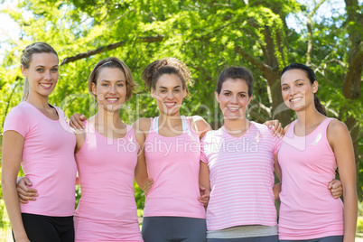 Smiling women in pink for breast cancer awareness