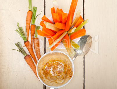 fresh hummus dip with raw carrot and celery