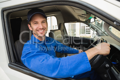 Delivery driver smiling at camera in his van