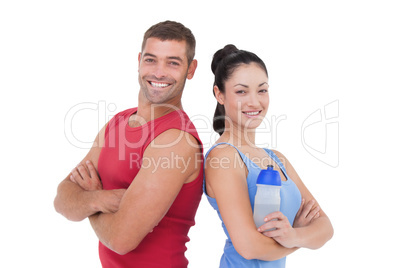 Fit man and woman smiling at camera together