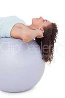 Fit woman doing sit ups on exercise ball