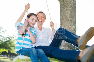 Happy blonde swing with her daughter