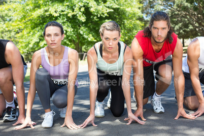 Fit people running race in park