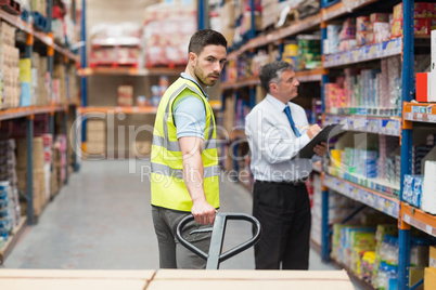 Warehouse worker talking with his manager