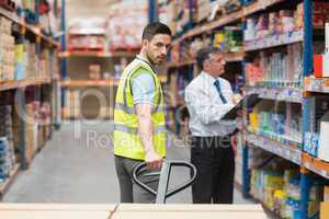 Warehouse worker talking with his manager
