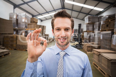 Happy warehouse manager making okay gesture