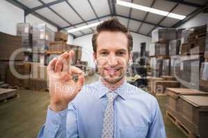 Happy warehouse manager making okay gesture