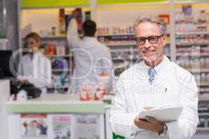 Senior pharmacist smiling at camera