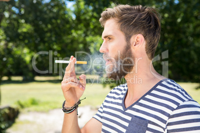 Hipster smoking electronic cigarette