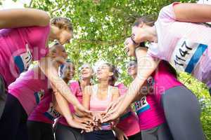 Smiling women running for breast cancer awareness