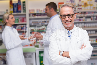 Senior pharmacist smiling at camera