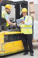 Forklift driver talking with his manager