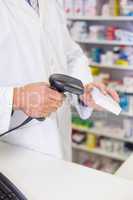 Pharmacist scanning medicines