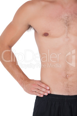 Fit shirtless man with hand on hip
