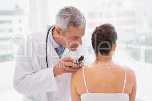 Doctor examining a spot at his patient