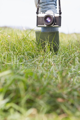 Woman in the park holding retro camera