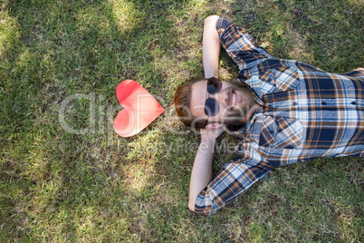 Handsome hipster relaxing in the park