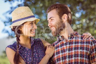 Hipster couple smiling at each other