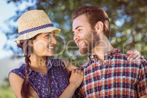Hipster couple smiling at each other