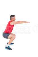 Fit man doing a squat