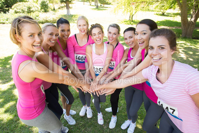 Smiling women running for breast cancer awareness