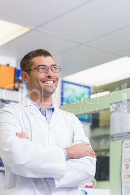 Handsome pharmacist smiling looking up