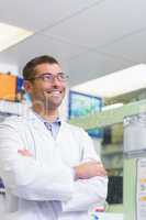 Handsome pharmacist smiling looking up