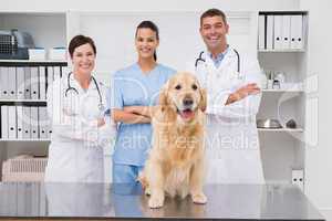 Veterinarian coworker smiling at camera with dog