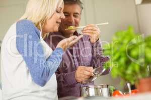 Mature couple preparing meal together