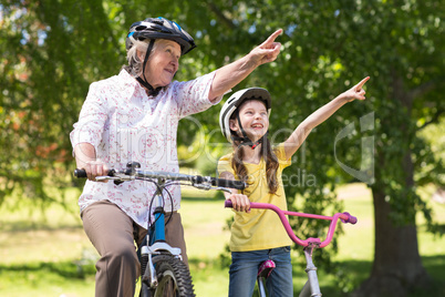 Happy grandmother with her granddaughter on their bike