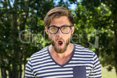 Shocked hipster looking at camera