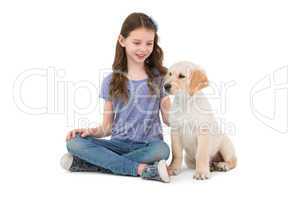 Smiling little girls sitting next to dog