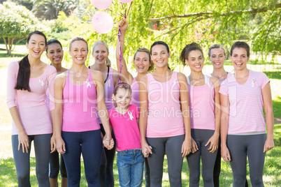 Smiling women in pink for breast cancer awareness