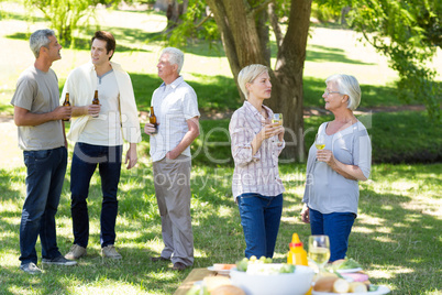 Happy family drinking in the park