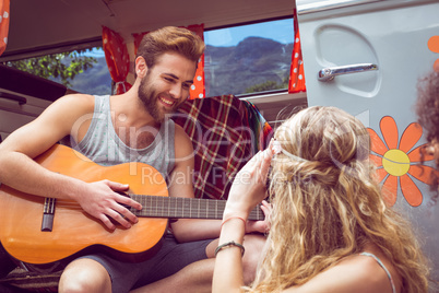 Hipster playing guitar for girls