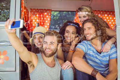 Hipster friends on road trip taking selfie