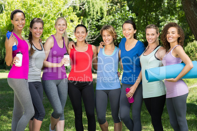 Fitness group smiling at camera in park