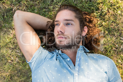 Young man lying down in the park