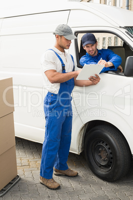 Delivery driver showing customer where to sign