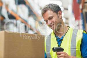 Smiling manual worker scanning package