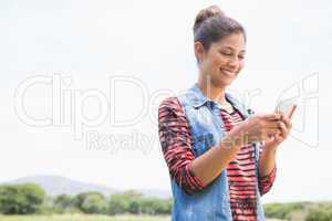 Pretty brunette texting in the park