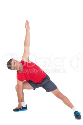 Fit man stretching his legs and arms