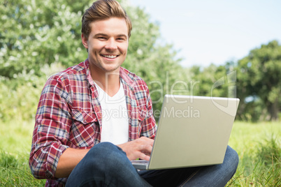 Man with laptop in park