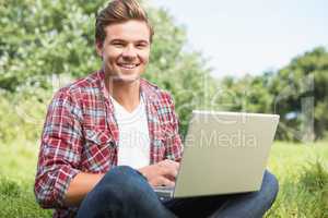 Man with laptop in park